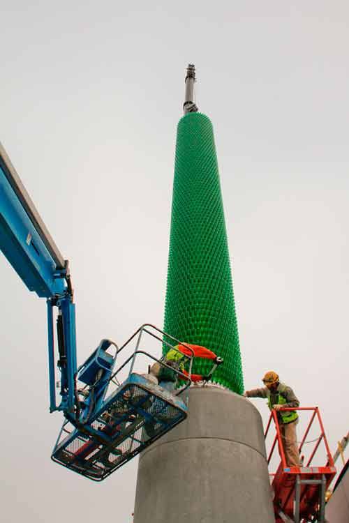 Workers today complete the installation of a 65-foot-tall glass tower art sculpture at the Brightwater Influent Pump Station