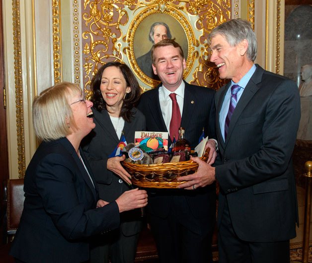 U.S. Senators Mark Udall (D-CO) and Michael Bennet (D-CO) make good on a friendly wager with U.S. Senators Patty Murray (D-WA) and Maria Cantwell (D-WA) after the Seattle Seahawks trounced the Denver Broncos 43-8 in Super Bowl XLVIII on Feb. 2.