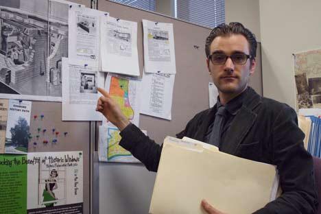 Lee O'Connor with the King County Historic Preservation Program points to copies of old news articles on homes in Kenmore. He works out of the County Administration Building in downtown Seattle.