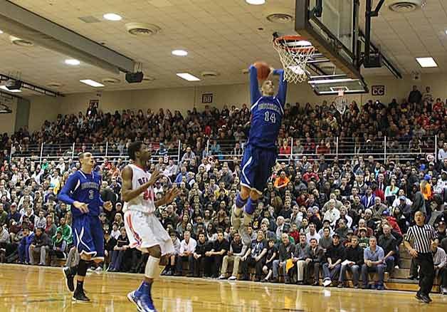 Bothell High School senior Zach LaVine flies through the air to a thunderous dunk during the King Holiday Hoopfest. LaVine is leading the Cougars