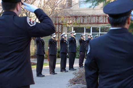 Bothell firefighters salute in honor of Denny Wright at his memorial service Dec. 2 at Eastside Foursquare Church in Bothell.