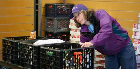 Hopelink volunteer Mary Rumpf hands out Thanksgiving goods on Wednesday.