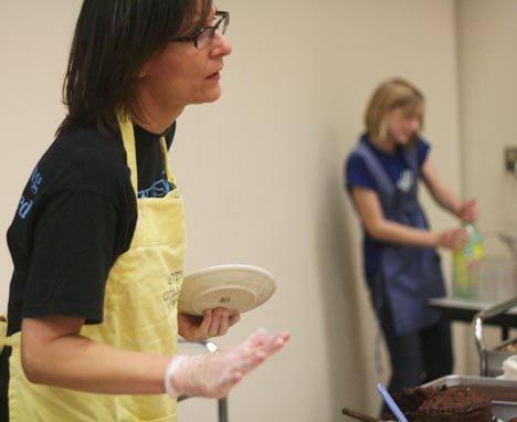 Bothell Community Kitchen coordinator Laura Dooley serves desserts while her daughter