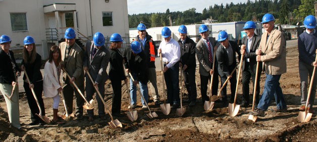 Bothell City Council and other influential members of the city dig in during a groundbreaking ceremony to kick start Bothell's new City Hall building.