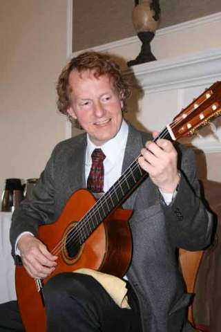 Bothell classical guitarist Gary Heimbigner performs at Chateau at Bothell Landing retirement center at lunchtime April 2. He started playing guitar at age 10