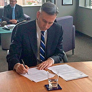 King County Executive Dow Constantine signs an executive order directing the King County Department of Transportation to work in concert with Sound Transit on joint planning of bus service and full integration of buses and rail.