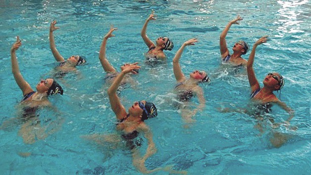 Seattle Synchro 13-15 Age Group swimmers warm up their gold medal routine. The team includes swimmers from the Eastside.