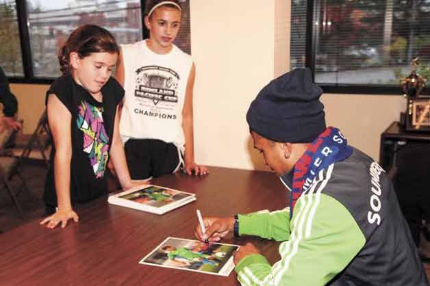 Northwest Nationals youth soccer players Kaeden Hansen and Keili Hansen of Bothell meet Seattle Sounders FC player DeAndre Yedlin.