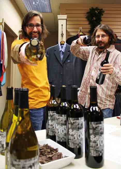 Wine pourers Darren Williams (left) and Jordan Rabinowe hang out at Paul Richard's Clothing during Friday's Vintage Bothell Wine Walk