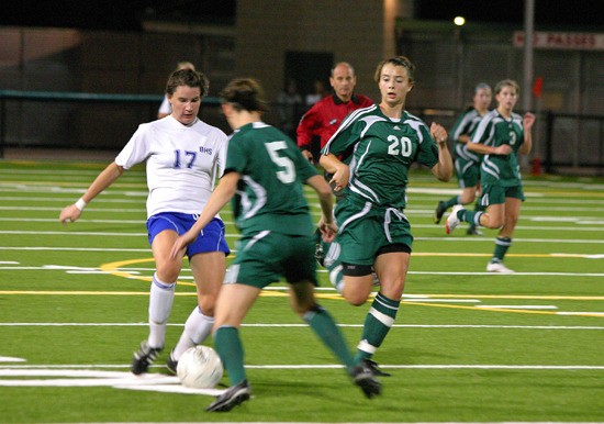 Bothell senior midfielder Shannon Schueren (No. 17) battles for the  ball with Falcons' midfielder Lilly Wilson.