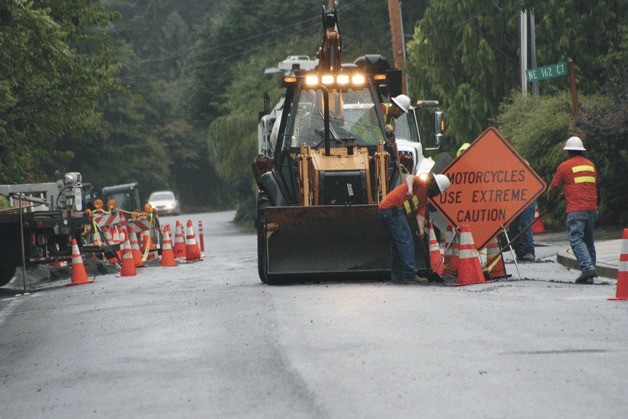 Work crews repair 81st Place N.E. in Kenmore from two water main breaks within one week on the street. The road was wavy in many places and had to be replaced.