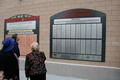 People peruse the Wall of Honor last September.