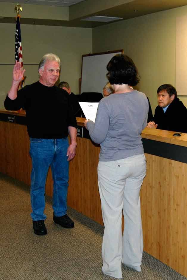 Jim McGaughey is sworn-in as a commissioner for Snohomish County Fire District 1. Administering the oath is Marsha Moore