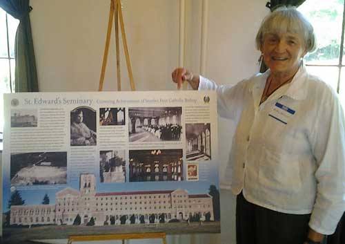 Artist Betty Watson displays one of the St. Edward's Seminary interpretive signs.