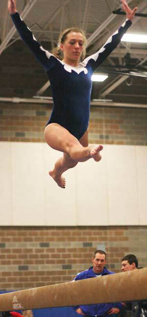 Bothell High senior Karli Bodine flies off the balance beam during Thursday night's home gymnastics meet against Newport High