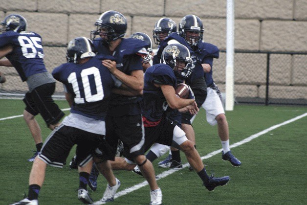 Eagles running back Andrew Rickman busts through the line during a recent preseason practice.