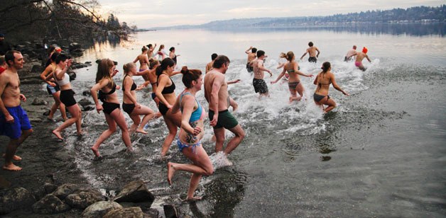 Bastyr University students and staff carry on tradition by plunging into the cold waters of Lake Washington Monday.