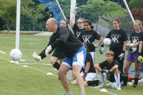 Kasey Keller tosses a ball out of the way as he awaits another shot this afternoon during a Northwest Soccer Camp session at Bastyr University. The former World Cup and Seattle Sounders goalkeeper is coaching this week at the camp