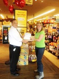 Thrasher’s Corner Safeway store manager Chris Vail recently presented a $2