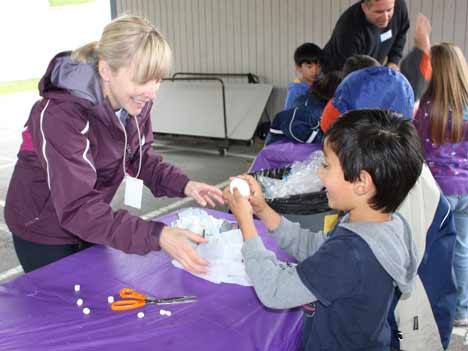 Lockwood Elementary kindergartener Akash Singh proudly examines his egg with PTA volunteer Leaanne Meschke at the recent Lockwood PTA Egg Drop. More than 180 Lockwood students put their science skills to the test by creating parachutes and other devices to protect their eggs from a drop from the Northshore Fire Departments' truck ladder. Seventy-five percent of those eggs survived drops ranging from 40 feet to 100 feet.