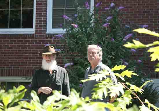 Mike and Brian McMenamin stand at the back of the Anderson Building at a community gathering in July 2010.