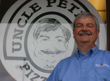 Pete Anthony and a caricature of the Uncle Peteza’s Pizzeria owner are all smiles. Anthony will be the grand marshal of Bothell’s Fourth of July Grand Parade.