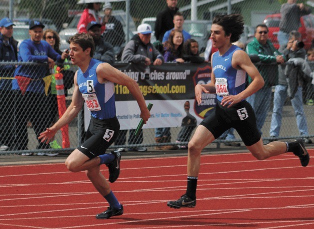 Bothell's Ryan Croson hands off to Matt Moran during the state prelim 4x100 relay at the 4A state meet at Mt. Tahoma High School in Tacoma on Friday