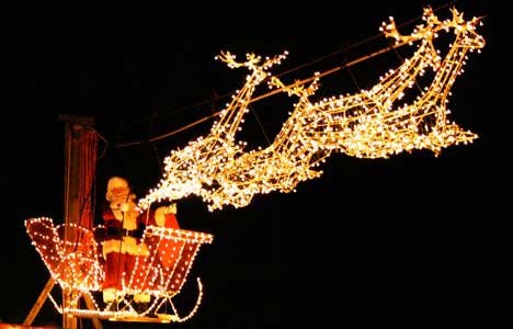 Santa rides in on a wire at Country Village last December.