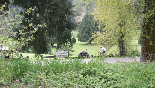 A bicyclist takes advantage of the warm weather by riding through the Red Brick Road loop in Bothell.