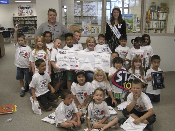 Fernwood Elementary first-grade teacher Nicole Ryan (middle) celebrates with her class after being named the STAR 101.5 Teacher of the Week.