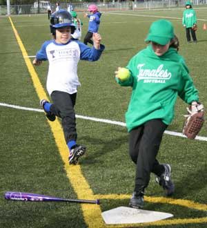 Tamale fielder Lyla Conrad forces Mustang runner Shaelyn Sharp out at home plate last March during a Northshore Girls Slowpitch Softball Association jamboree game at North Creek Fields. The Mustangs won the first- and second-grader-division game.