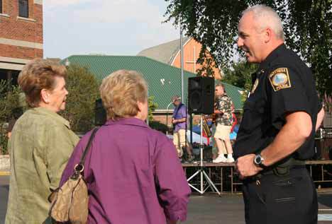 Bothell Police Department Deputy Chief Henry Simon chats with Marlies Rettenbacher