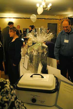 Rotary Club members eye gift items during the silent auction.