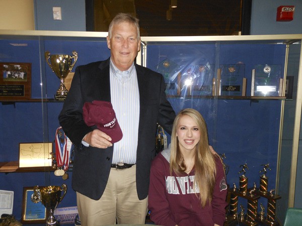 Cedar Park Christian senior Rachel Staudacher and head basketball coach Alan Dickson pose for a photo during Staudacher's signing ceremony at the school