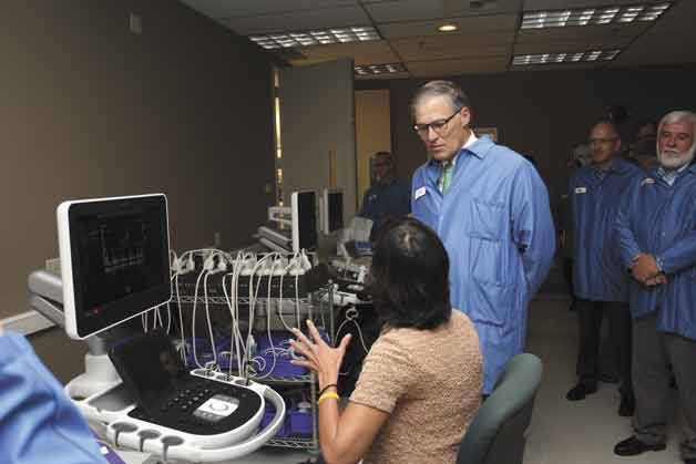 Gov. Jay Inslee gets an education in the EPIQ ultrasound from ultrasonographer Joyce MacKay during a tour of Philips manufacturing in Bothell on Wednesday morning.