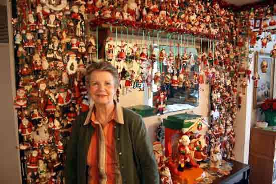 Mae Wood is surrounded by Santas in her Kenmore home’s entryway. “They make me happy