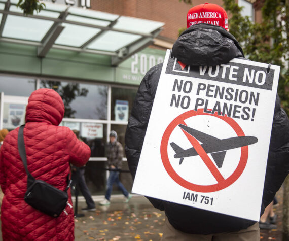 Larry Best, a customer coordinator for quality assurance who has worked at Boeing for 38 years, stands outside of Angel of the Winds Arena with a “vote no” sign on Monday in Everett. (Olivia Vanni / The Herald)